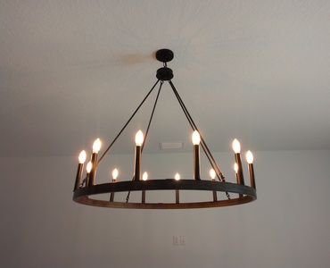 Barn style chandelier hanged on ceiling.