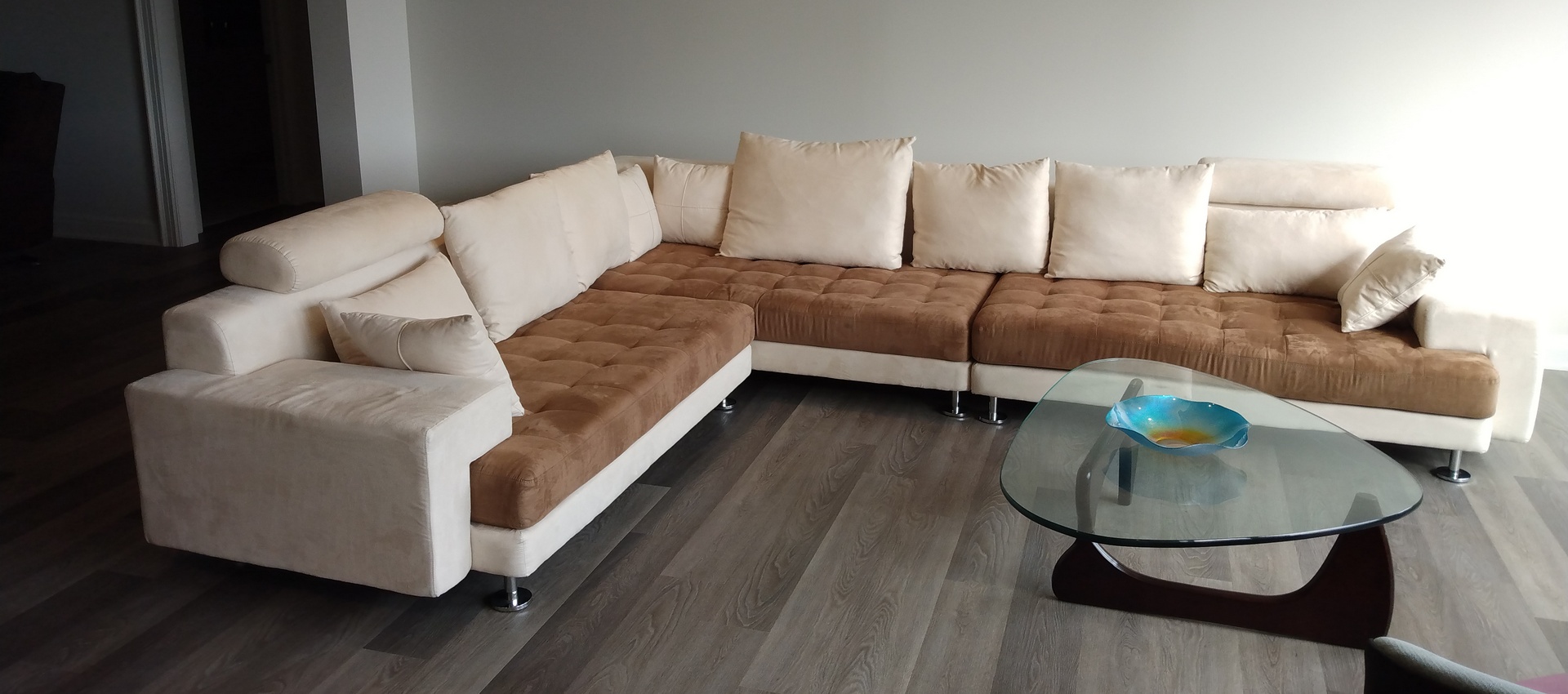 L-shape milk and brown sofa and glass table. How to get furniture assembled and save? - Pro Furniture Assembly.