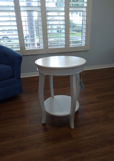 White round top end table assembled.