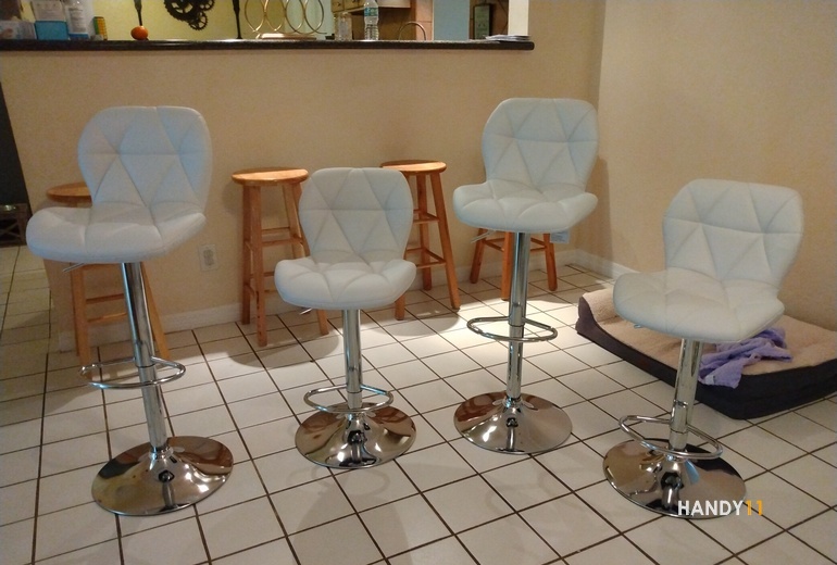 Four White soft leather silver leg bar stools.