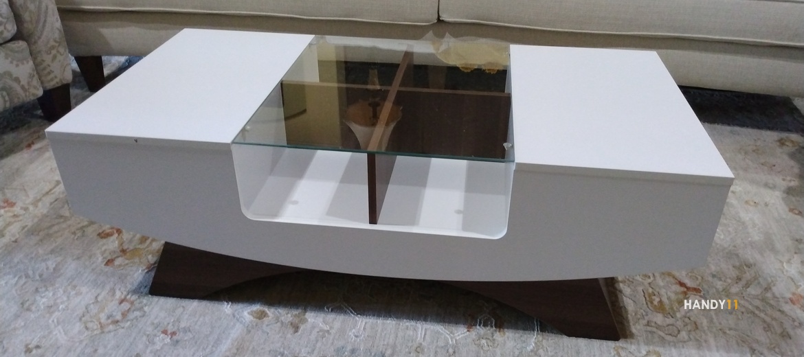 White-brown coffe table with glass top assembled.