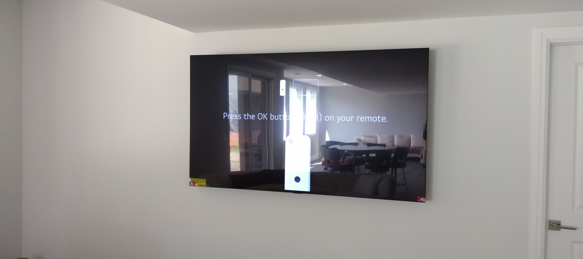 TV mounted on drywall with in-wall wiring.