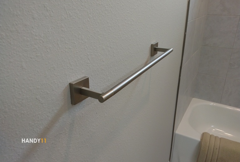 Grab bar is mounted in a bath room.
