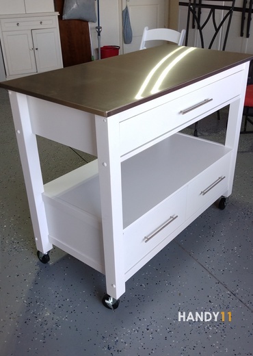 White wood silver metal top kitchen table with 3 drawers.