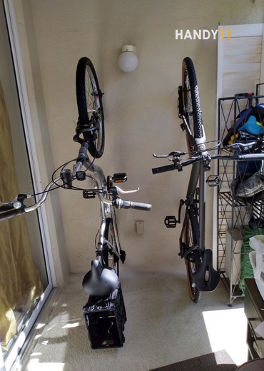 2 bikes hanged on wall with bike-mount