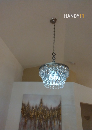 High angled ceiling cristals chandelier hanged.