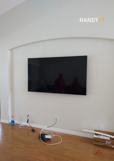 TV mounted on the wall with wires hidden.