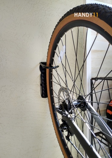 Bikes wheel on bike-hook on the wall