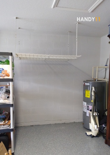 White metal garage shelf mounted.