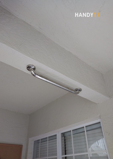 Grab bar mounted on ceiling.